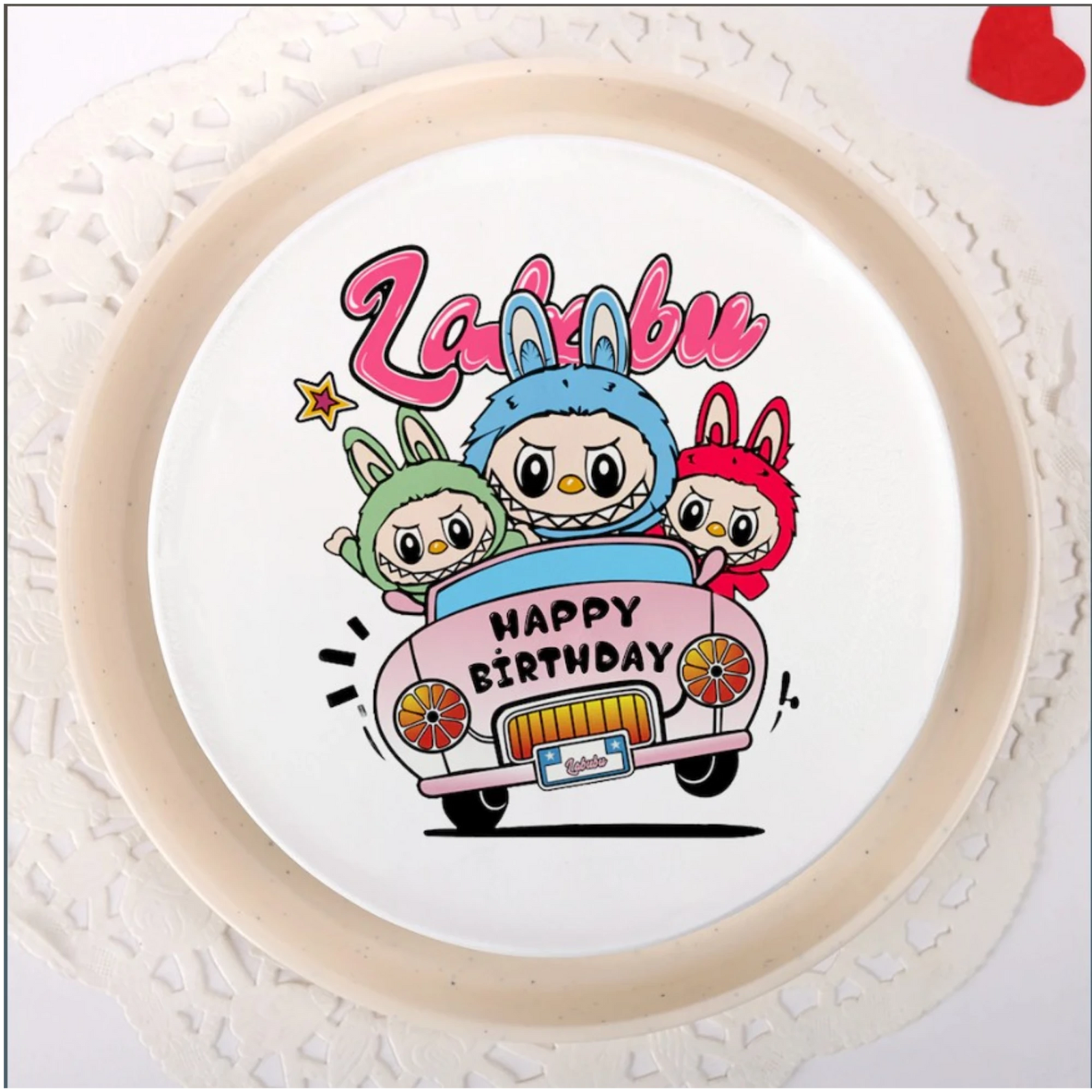 Close-up of birthday cake with cartoon characters and hearts