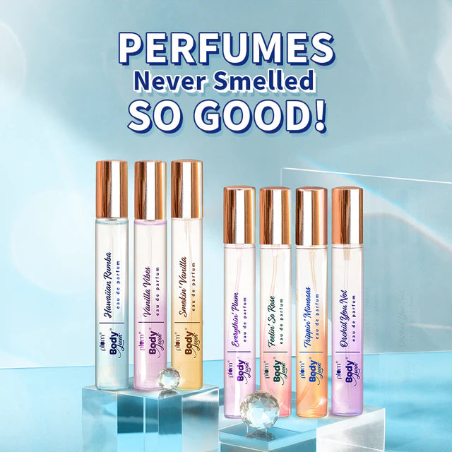 Lineup of Plum BodyLovin' Eau de Parfum 15ml bottles including Hawaiian Rumba, displayed on clear stands for gifting or travel.