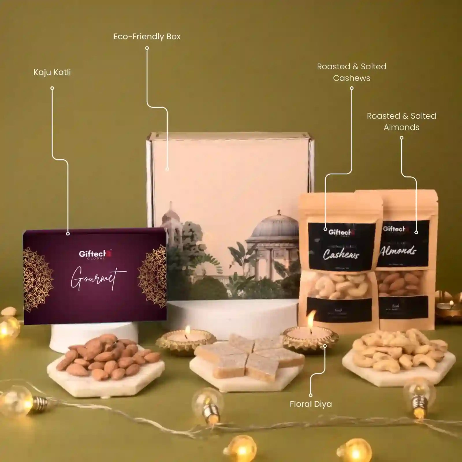 Gifteet gourmet gift set with eco-friendly box, cashews, almonds, and floral diya on a green background.