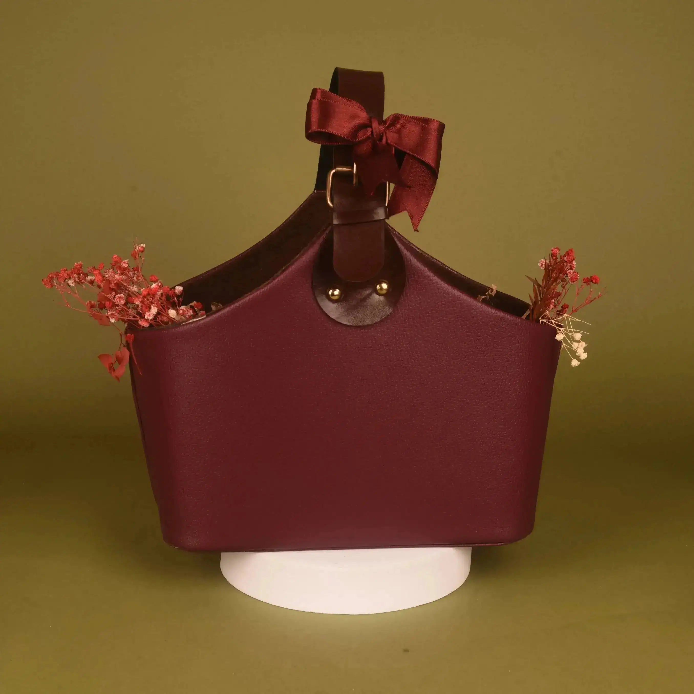 Elegant maroon leather basket with bow from The Aura Hamper - Festive Luxury Gift, reusable for stylish storage or gifting.