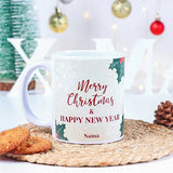 Mug with 'Merry Christmas & Happy New Year' text on a decorative surface with cookies and a blurred festive background.