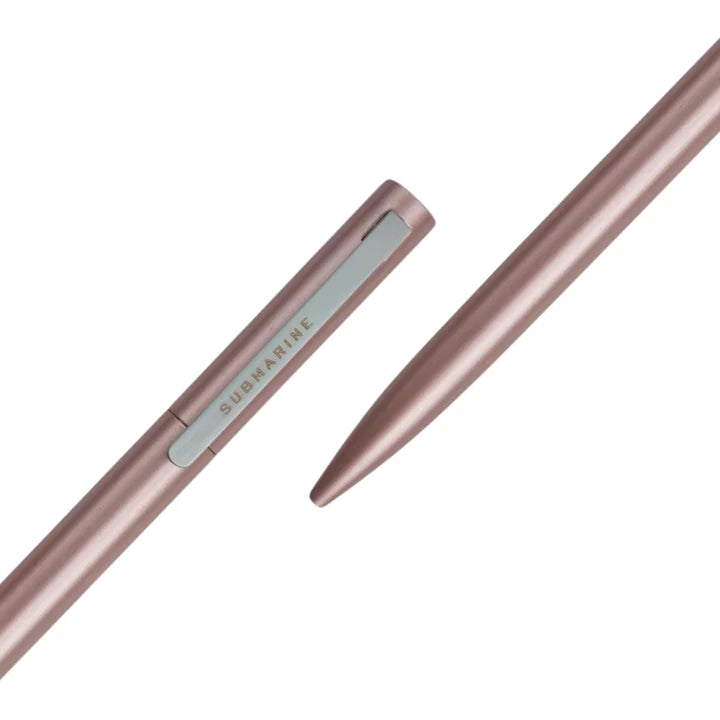 Rose gold pen on a white background