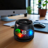 Black cylindrical device with colorful LED lights on a desk