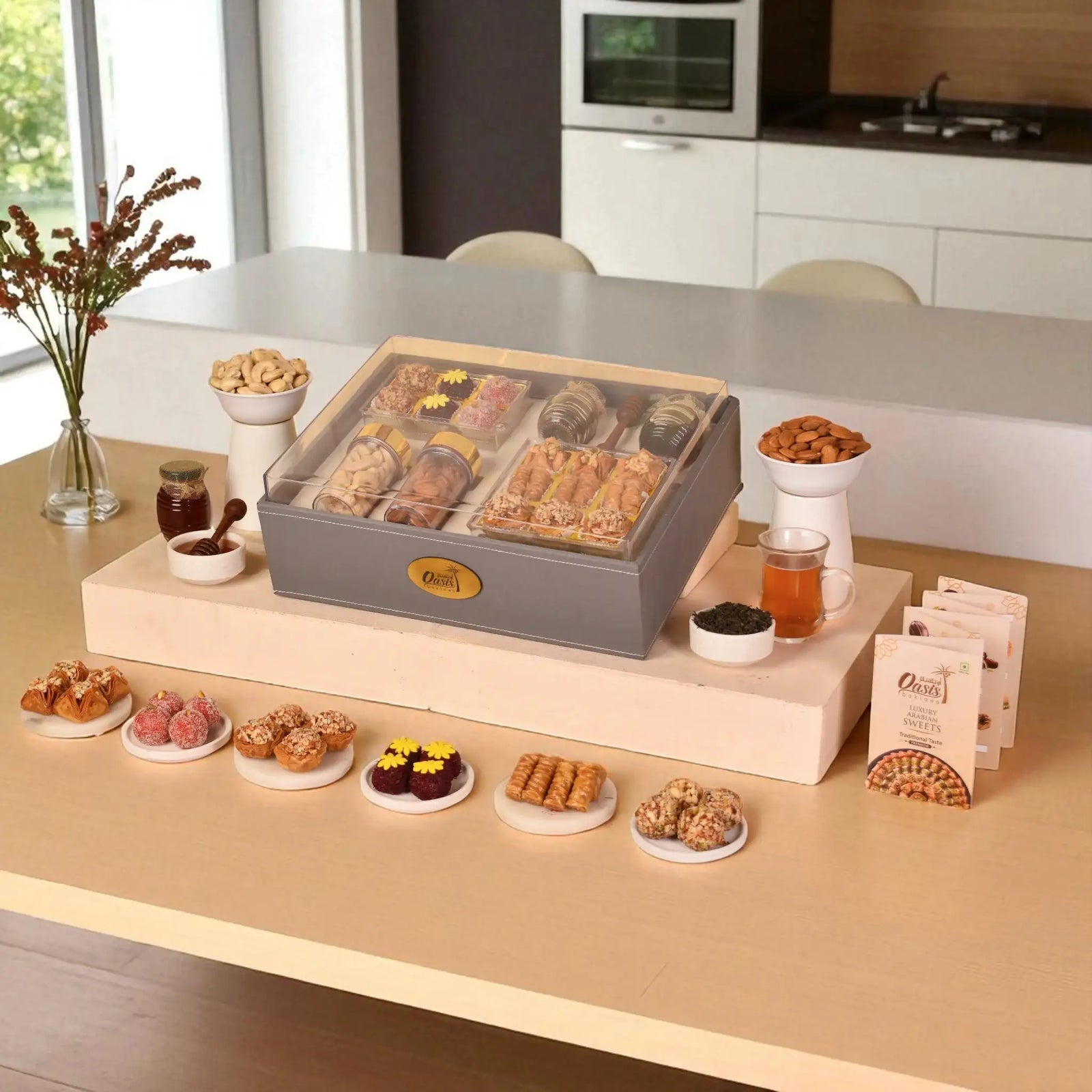 The Regal Treat Box festive gift hamper with assorted sweets, plain cashews, almonds, and premium tea jar, ideal for elegant celebrations.