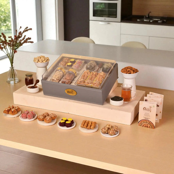 The Regal Treat Box festive gift hamper with assorted sweets, plain cashews, almonds, and premium tea jar, ideal for elegant celebrations.