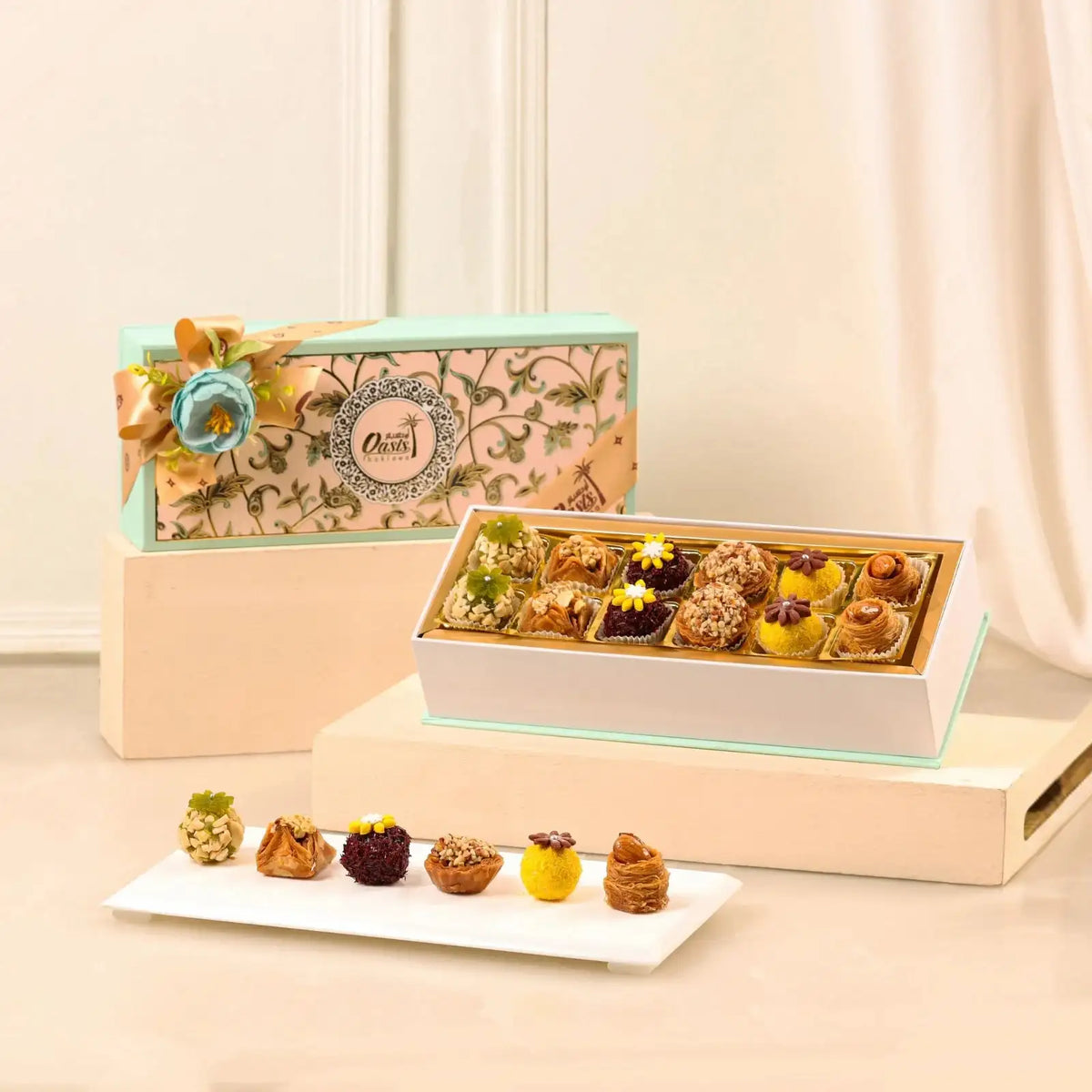 Blissful Bites Gourmet Hamper | Gift Hampers Online featuring an elegant box of assorted premium sweets with floral garnish, ideal for festive gifting.