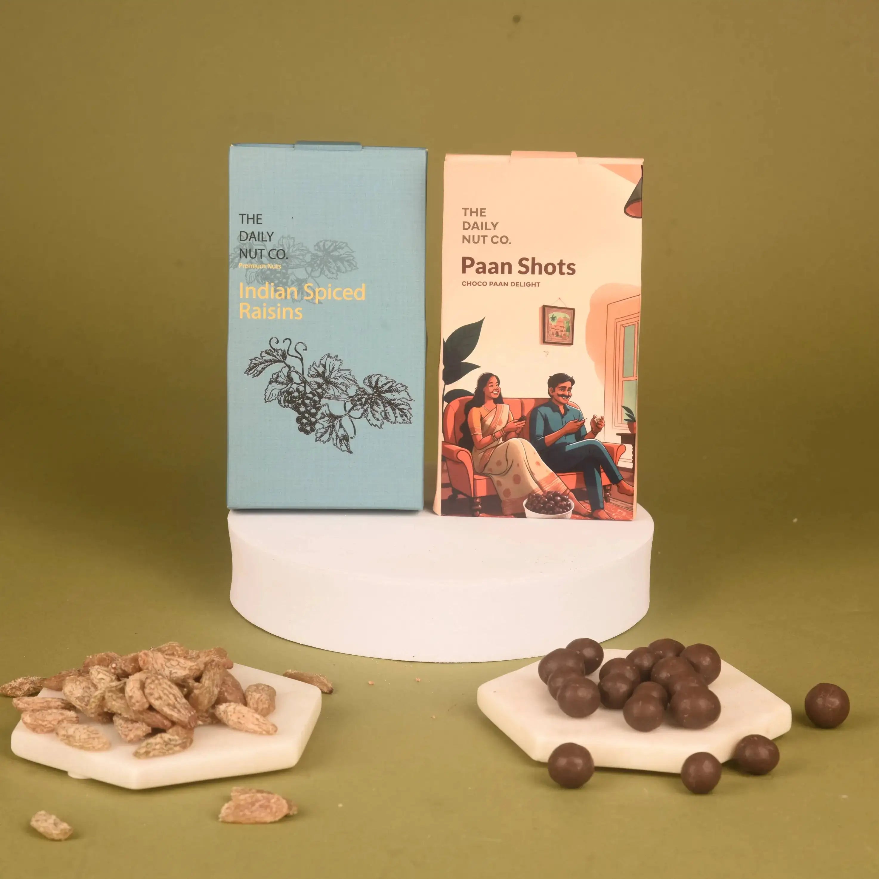 The Daily Nut Co. Indian Spiced Raisins and Paan Shots from the Layers of Luxury Hamper, offering unique festive flavors.