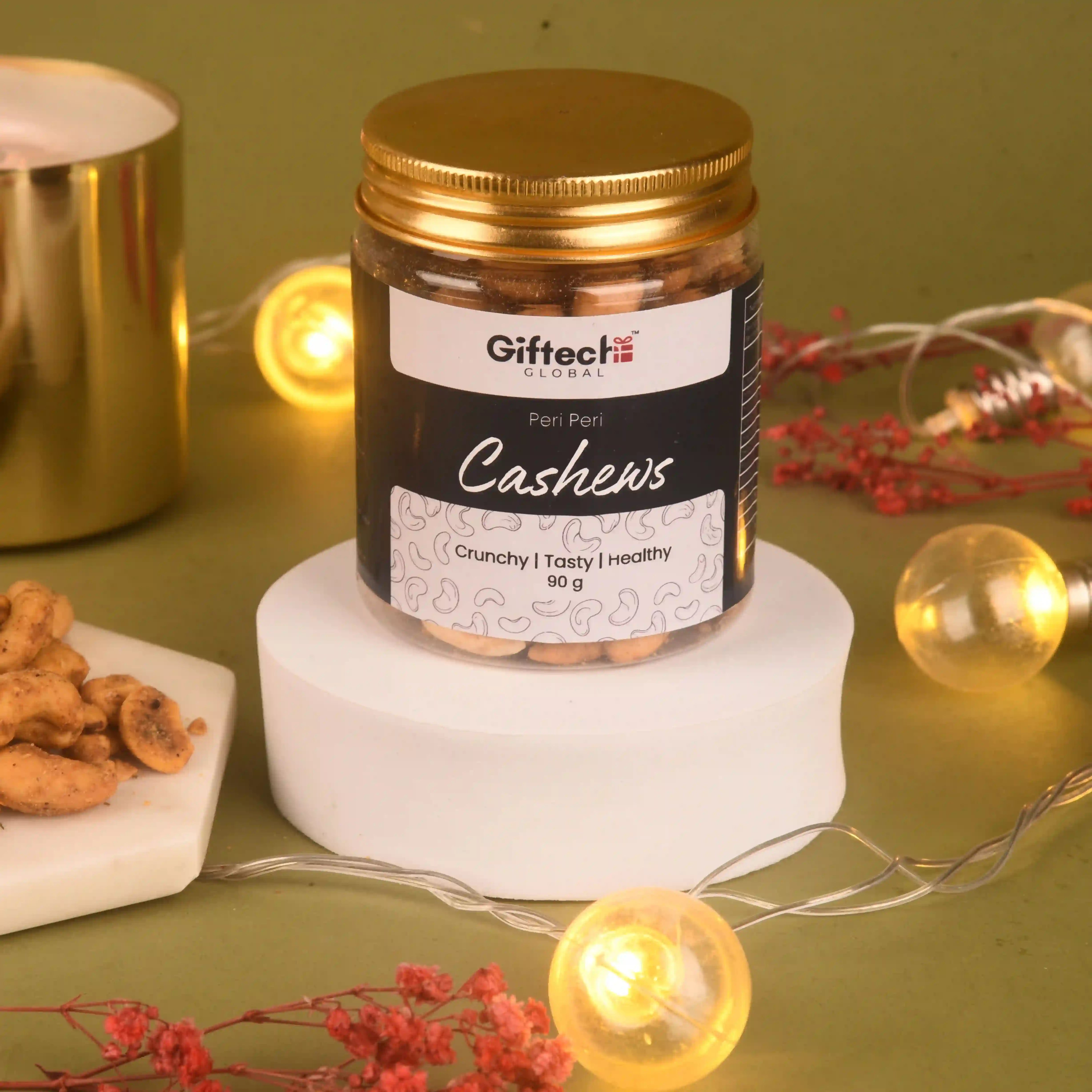 Jar of Giftech Global Cashews on a decorative surface with lights and snacks.