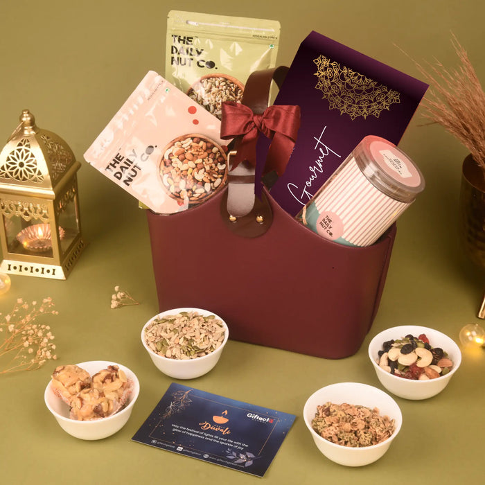 Health Basket - Power & Wellness with seed mixes, dry fruit bites, laddoos, and gourmet snacks in a maroon gift hamper, ideal for Diwali gifting.