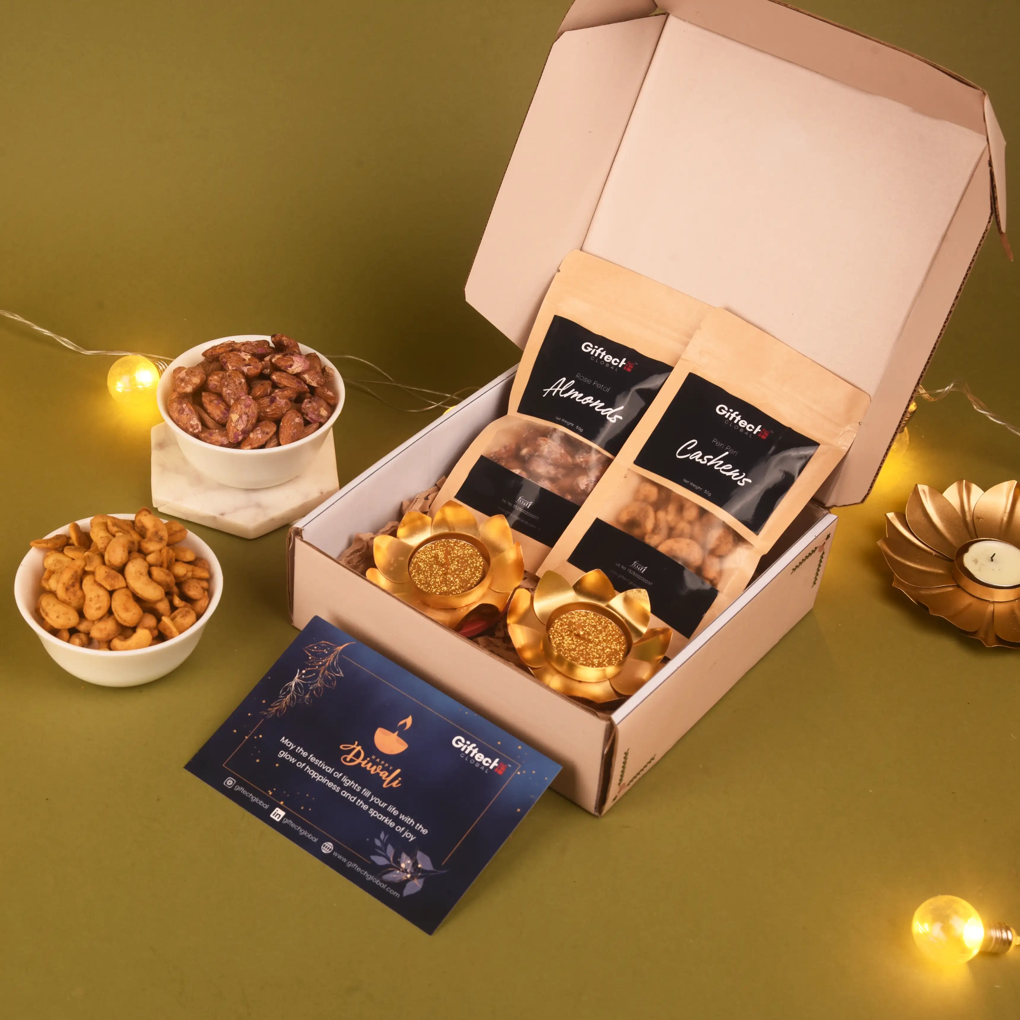 Open box of Oiftec Diwali gift set with gold items and nuts on a green background