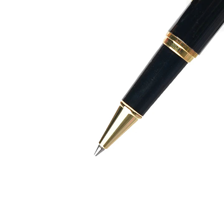 Black pen with gold accents on a white background