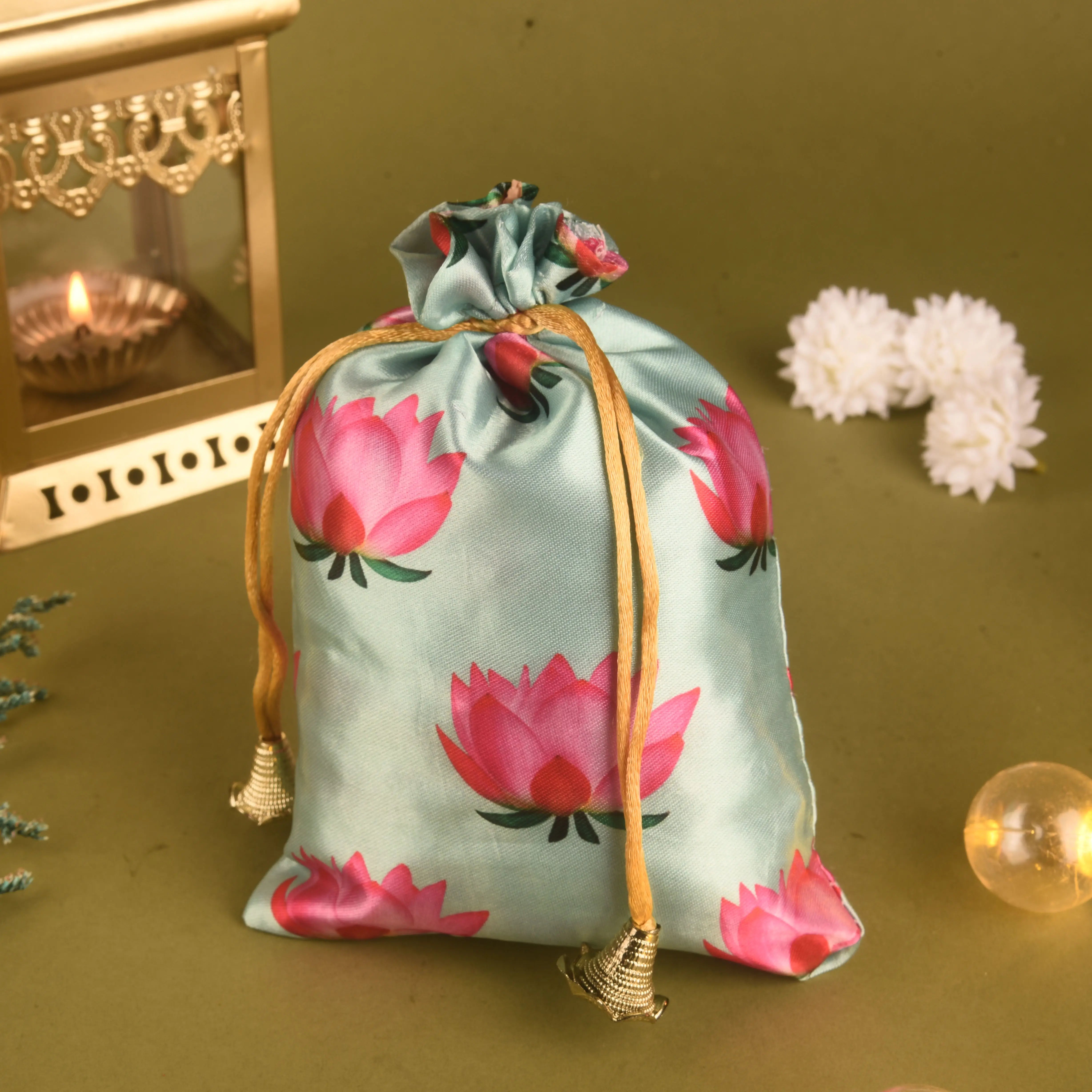 Decorative drawstring bag with pink floral design on a green background