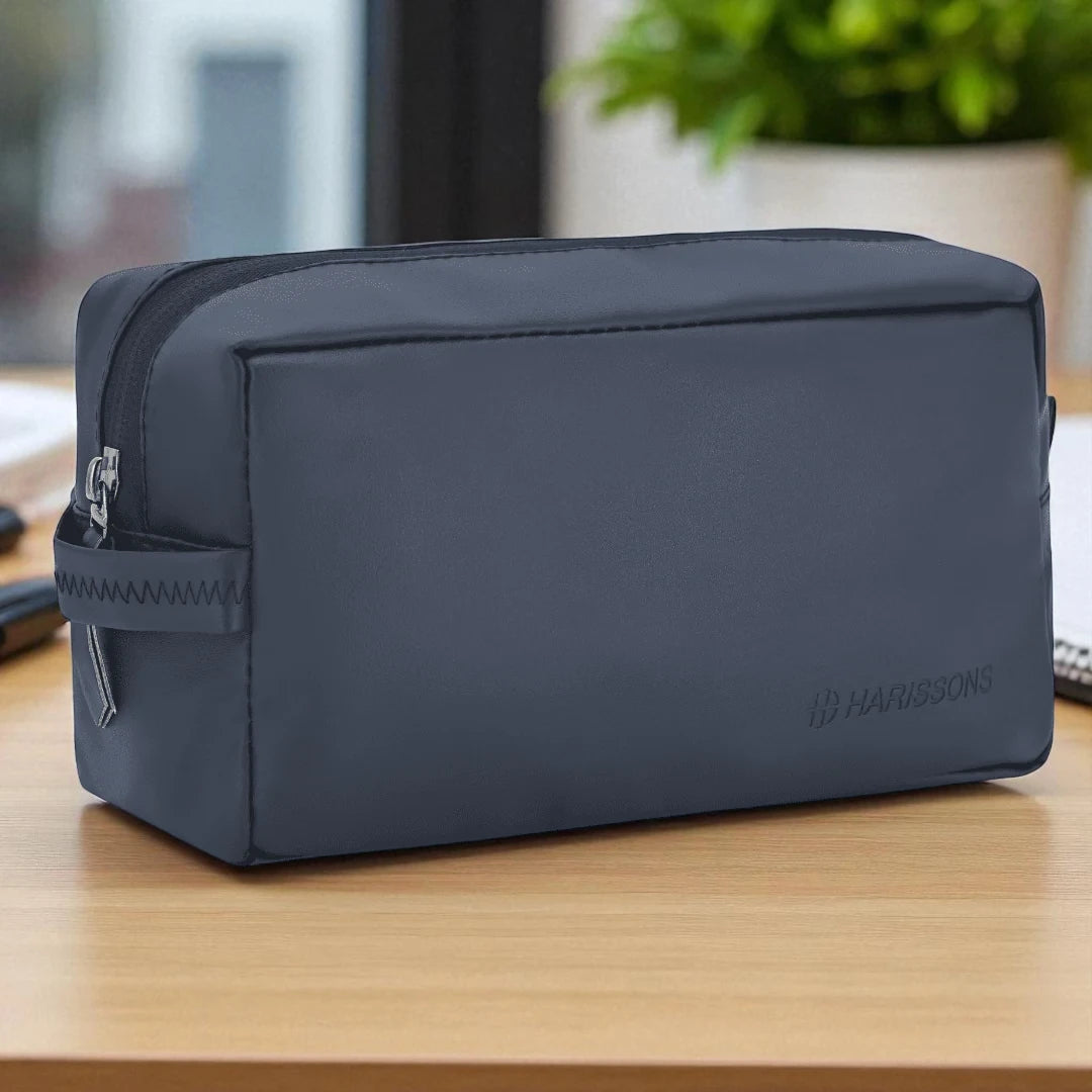 Black toiletry bag on a wooden surface with a blurred background