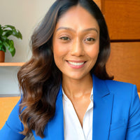 Woman wearing a blue blazer and white shirt in an office setting