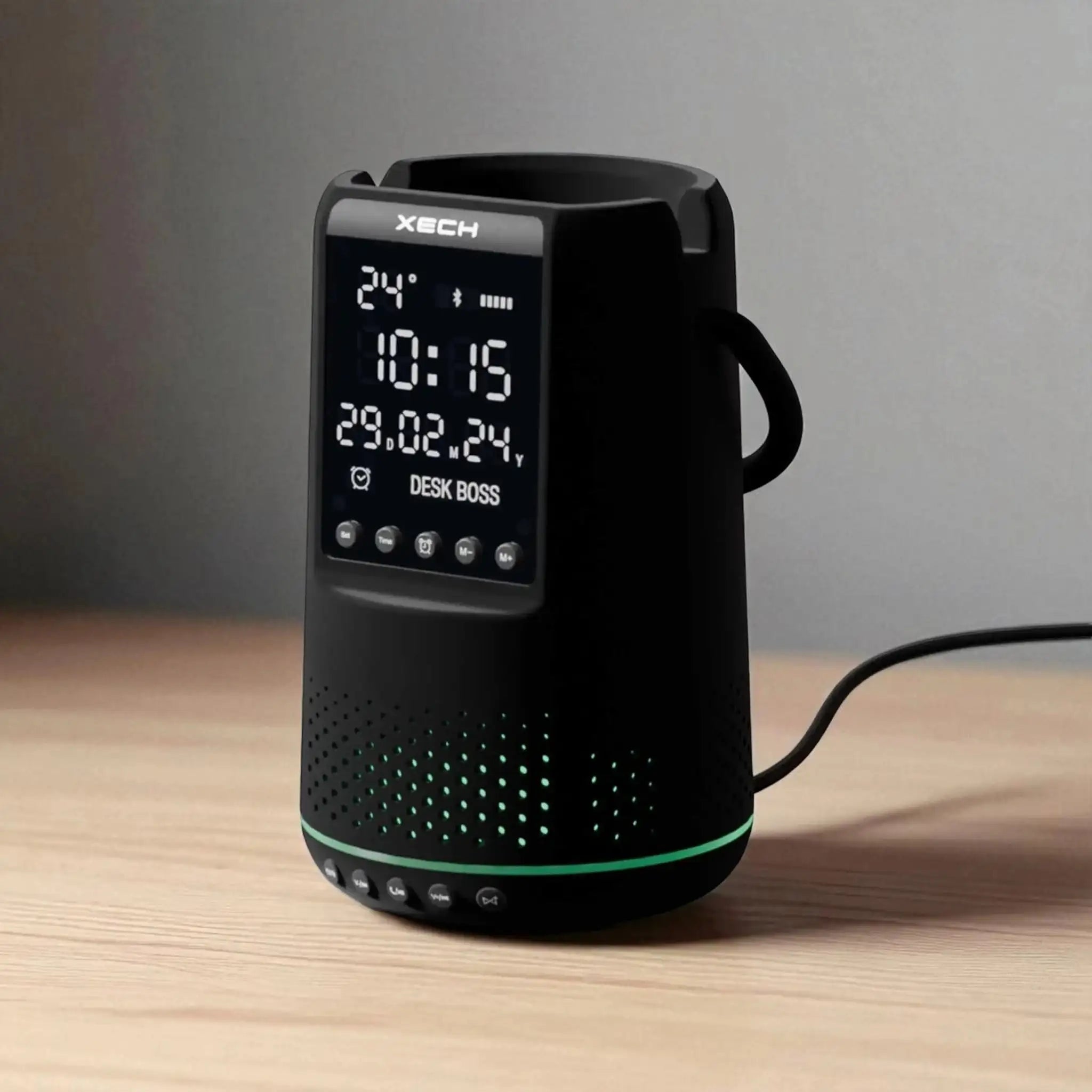 Black digital clock with Xtech branding on a wooden surface