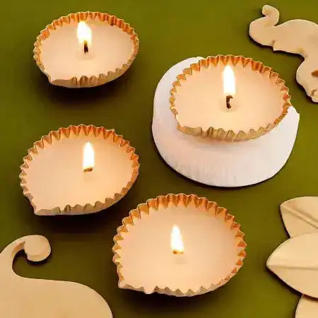 Set of four lit metal diyas from Spark Joy Basket - Diwali Gift Mithai & Diyas, adding festive glow to Diwali decor.