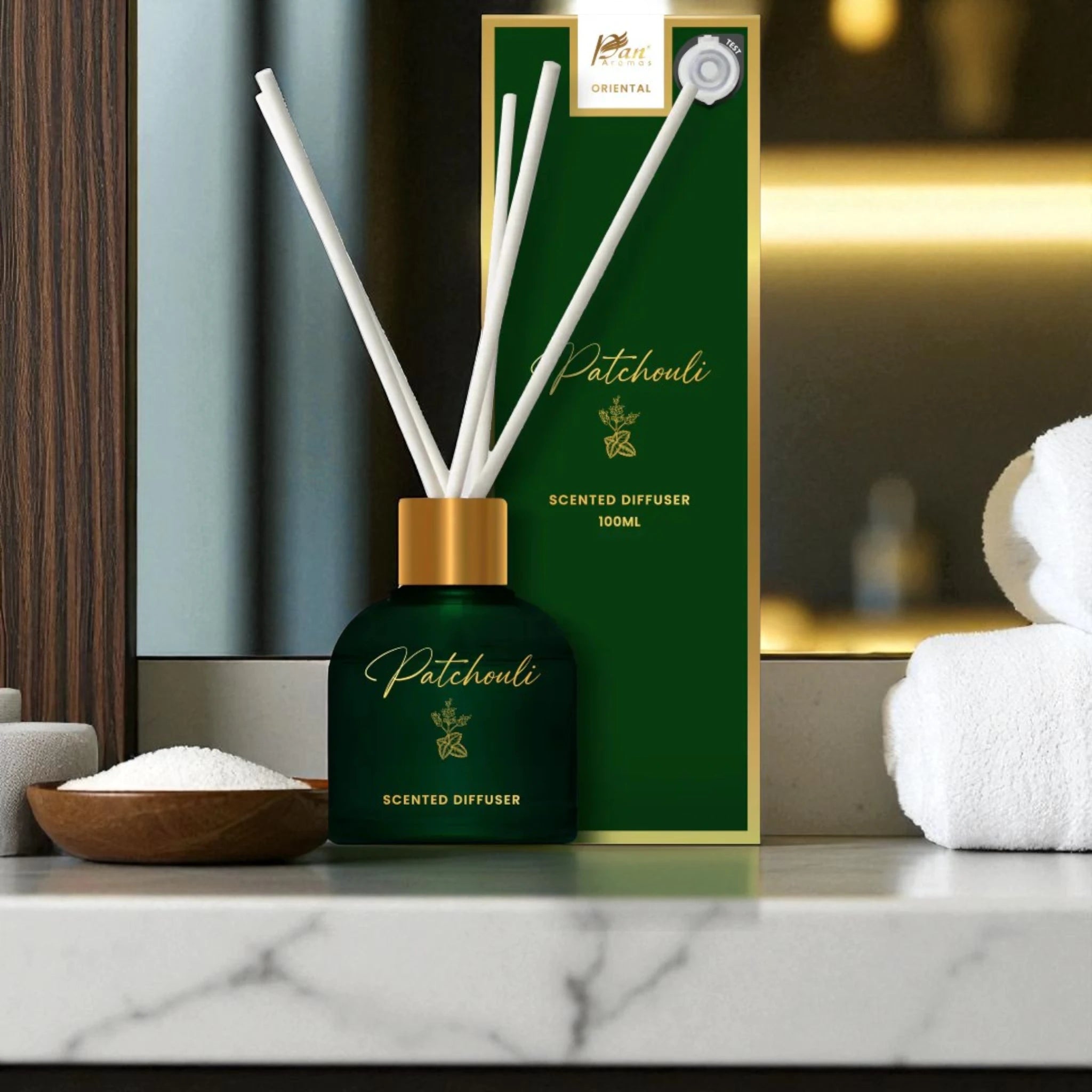 Patchouli scented diffuser with packaging on a marble surface