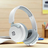 White and gray headphones on a desk 